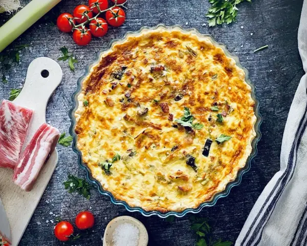 Herzhafte Lauch-Quiche mit Speck und Kräutern, eine köstliche Idee für Lauch Rezepte.