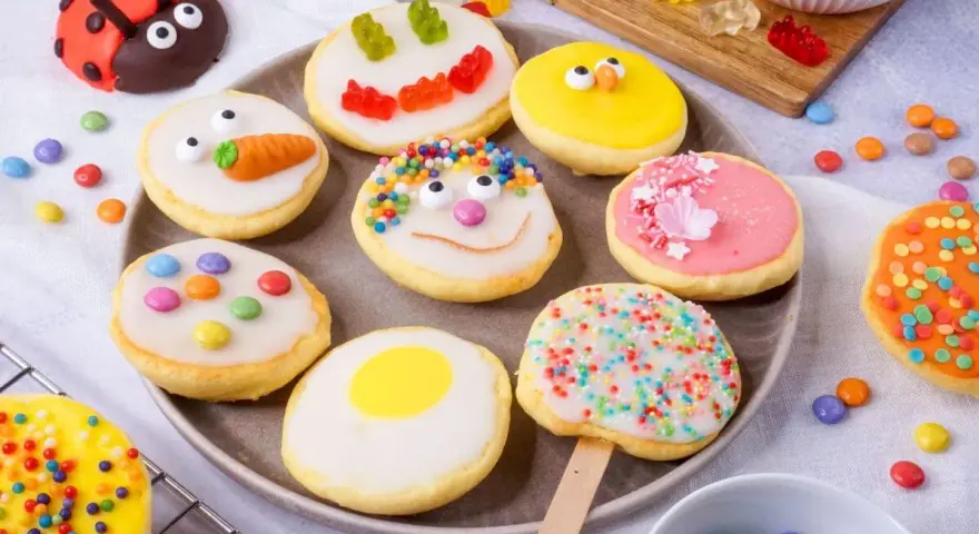 Bunte mini Amerikaner mit lustigen Gesichtern, Marienkäfer und Karotte. Ein süßer Genuss für Groß und Klein.