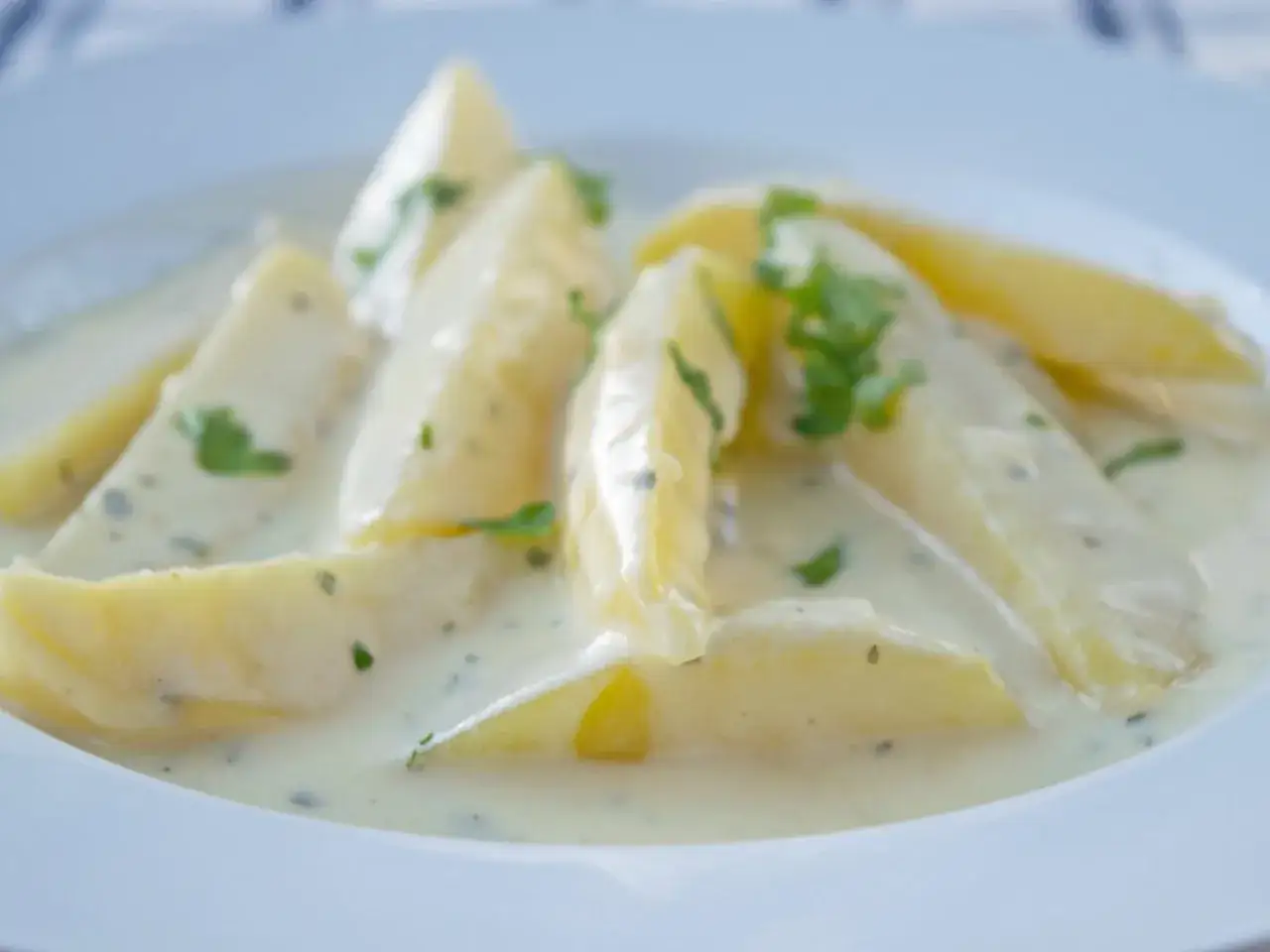 Kartoffelspalten in cremiger Sauce mit Kräutern, ein köstliches Gericht, das an Schabzigerklee Rezepte erinnert.
